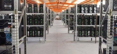 An indoor view of a mining farm, showcasing rows of servers and cooling systems.